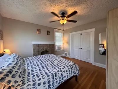 a bedroom with a bed and a ceiling fan at Rolston 2, Two Bedroom near Xavier Downtown in Bellevue