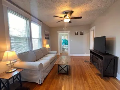 a living room with a white couch and a flat screen tv at Rolston 2, Two Bedroom near Xavier Downtown in Bellevue