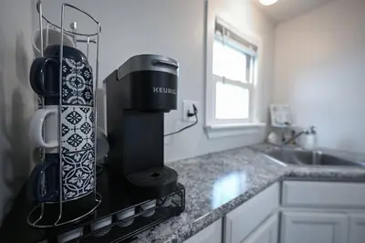 a kitchen with a coffee maker on a counter at Recharge & Reconnect Your cozy Vermilion nest in Vermilion