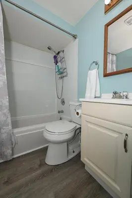 a bathroom with a toilet and a sink and a mirror at Recharge & Reconnect Your cozy Vermilion nest in Vermilion