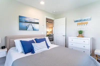 a bedroom with a bed with blue and white pillows at Renovated Retreat Home in Huron, close to beaches in Huron