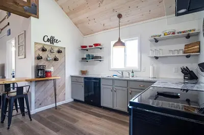 a kitchen with a black island in a room at Renovated Retreat Home in Huron, close to beaches in Huron