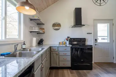 a kitchen with a sink and a stove at Renovated Retreat Home in Huron, close to beaches in Huron