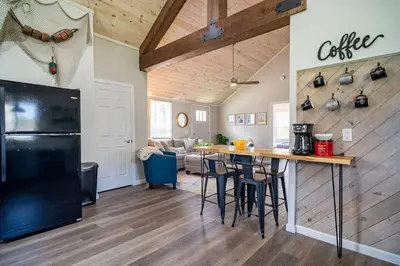 a kitchen and living room with a black refrigerator at Renovated Retreat Home in Huron, close to beaches in Huron