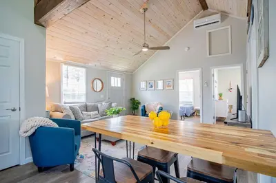 a dining room with a wooden table and blue chairs at Renovated Retreat Home in Huron, close to beaches in Huron