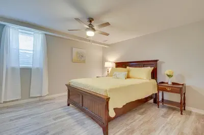 a bedroom with a bed and a ceiling fan at Home with Hot Tub and Deck about 3 Mi to Ark Encounter! in Williamstown