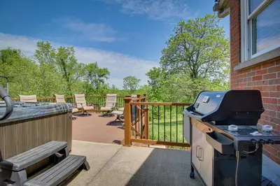 a backyard with a grill and chairs on a deck at Home with Hot Tub and Deck about 3 Mi to Ark Encounter! in Williamstown