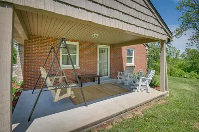 a porch with a swing and a table and chairs at Home with Hot Tub and Deck about 3 Mi to Ark Encounter! in Williamstown