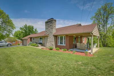 a house with a grass yard in front of it at Home with Hot Tub and Deck about 3 Mi to Ark Encounter! in Williamstown
