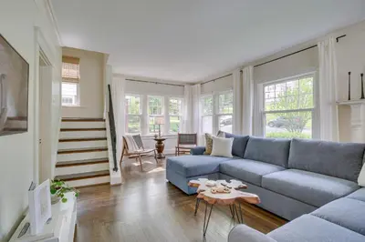a living room with a blue couch and a table at Pet-Friendly Cincinnati Retreat with Hot Tub in Blue Ash