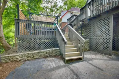 a staircase leading up to a house with a gate at Pet-Friendly Cincinnati Retreat with Hot Tub in Blue Ash