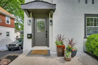 a front door of a white house with plants at Pet-Friendly Cincinnati Retreat with Hot Tub in Blue Ash