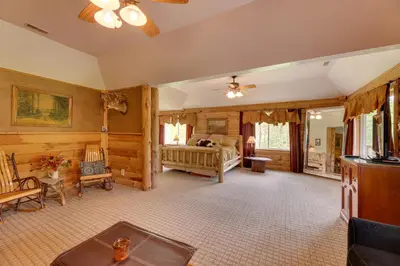 a living room with a bed and a couch at Fraziers Bottom Cabin on 800 Acres of Land with Lake in Fraziers Bottom