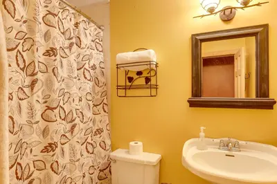 a bathroom with a sink and a toilet and a mirror at Fraziers Bottom Cabin on 800 Acres of Land with Lake in Fraziers Bottom