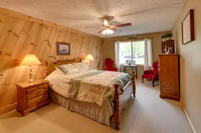 a bedroom with a bed and a ceiling fan at Fraziers Bottom Cabin on 800 Acres of Land with Lake in Fraziers Bottom