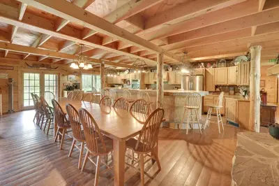 a dining room and kitchen with a table and chairs at Fraziers Bottom Cabin on 800 Acres of Land with Lake in Fraziers Bottom