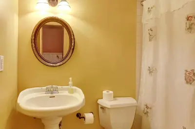 a bathroom with a sink and a toilet and a mirror at Fraziers Bottom Cabin on 800 Acres of Land with Lake in Fraziers Bottom