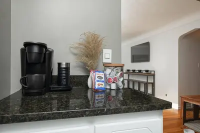 a kitchen with a counter top with a coffee maker at Parma Home w/ Hot Tub and Arcade room! in Parma
