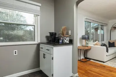 a living room with a couch and a window at Parma Home w/ Hot Tub and Arcade room! in Parma