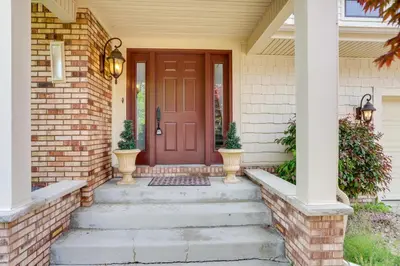 a front door of a house with a red door at Waterfront Luna Pier Home 14 Mi to Downtown Toledo in Erie