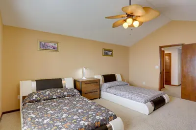 a bedroom with two beds and a ceiling fan at Waterfront Luna Pier Home 14 Mi to Downtown Toledo in Erie