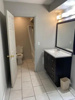 a bathroom with a sink and a toilet and a mirror at New Budget Inn in Eaton