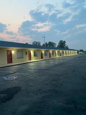 an empty parking lot in front of a motel at New Budget Inn in Eaton