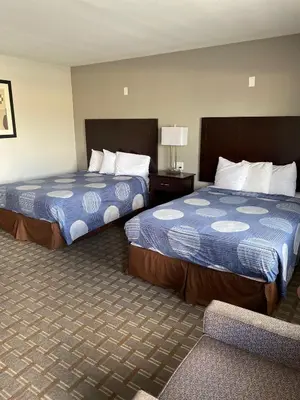 a hotel room with two beds in a room at New Budget Inn in Eaton