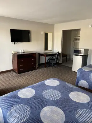 a hotel room with a bed and a desk at New Budget Inn in Eaton