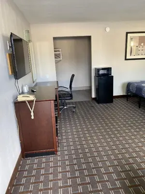 an office with a desk and a bed and a room at New Budget Inn in Eaton