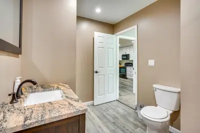 a bathroom with a toilet and a sink at Waterfront Buckeye Lake Vacation Rental with Hot Tub in Hebron