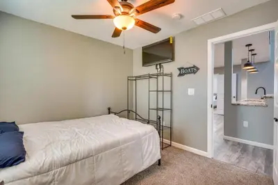 a bedroom with a bed and a ceiling fan at Waterfront Buckeye Lake Vacation Rental with Hot Tub in Hebron
