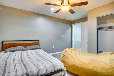 a bedroom with a bed and a ceiling fan at Waterfront Buckeye Lake Vacation Rental with Hot Tub in Hebron