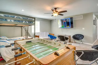 a room with bunk beds and a ceiling fan at Waterfront Buckeye Lake Vacation Rental with Hot Tub in Hebron