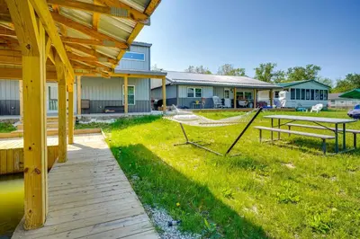 a yard with a hammock and a house at Waterfront Buckeye Lake Vacation Rental with Hot Tub in Hebron
