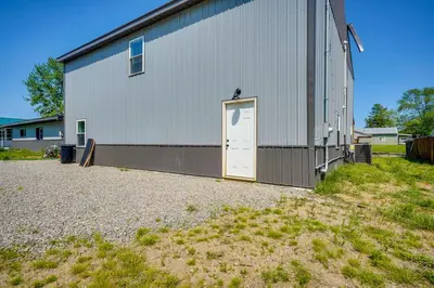 a large white building with a door on the side at Waterfront Buckeye Lake Vacation Rental with Hot Tub in Hebron
