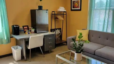 a living room with a couch and a table with a tv at Upstage Stay in Bainbridge