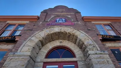 a brick building with a sign above a door at Upstage Stay in Bainbridge