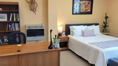 a bedroom with a bed and a tv at Upstage Stay in Bainbridge