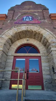 a red door of a building with a sign above it at Upstage Stay in Bainbridge