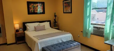 a bedroom with a bed and a window at Upstage Stay in Bainbridge