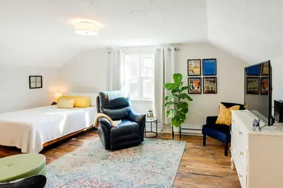 a bedroom with a bed and a chair at Cozy Norwalk Apt Near Cedar Point and Kalahari! in Norwalk