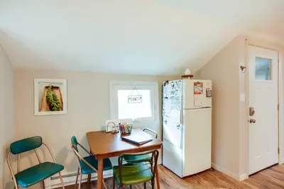 a kitchen with a table and a refrigerator at Cozy Norwalk Apt Near Cedar Point and Kalahari! in Norwalk