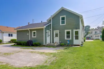 a green house with a yard in front of it at Cozy Norwalk Apt Near Cedar Point and Kalahari! in Norwalk