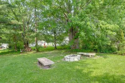 a park with two benches and a tree at Cozy Norwalk Apt Near Cedar Point and Kalahari! in Norwalk