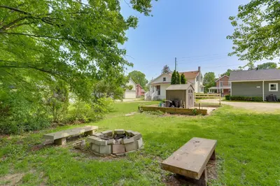 a park with two benches and a fire pit at Cozy Norwalk Apt Near Cedar Point and Kalahari! in Norwalk