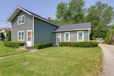 a blue house with a lawn in front of it at Cozy Norwalk Apt Near Cedar Point and Kalahari! in Norwalk