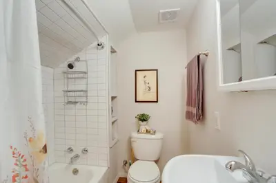 a bathroom with a toilet and a tub and a sink at Cozy Norwalk Apt Near Cedar Point and Kalahari! in Norwalk