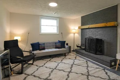 a living room with a couch and a fireplace at 3BR Home for 8 - Only 5 Minutes to Ark - Foosball in Williamstown