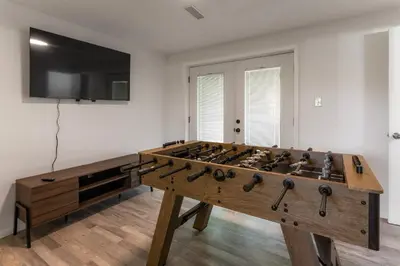 a large wooden foosball table in a room at 3BR Home for 8 - Only 5 Minutes to Ark - Foosball in Williamstown